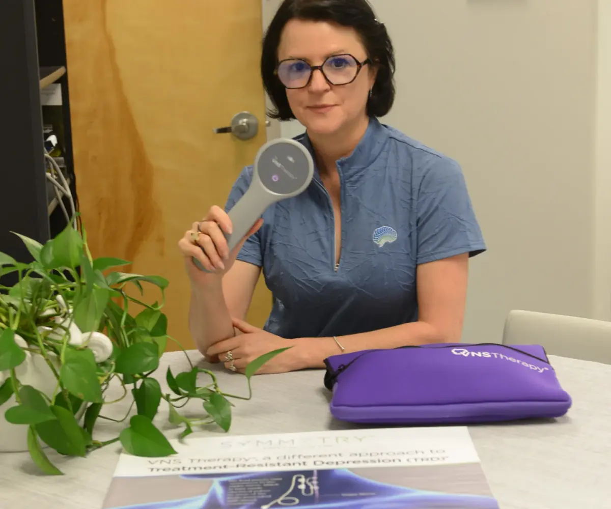 Dr. Alina Galliano demonstrating VNS Therapy materials at BioMental Clinic