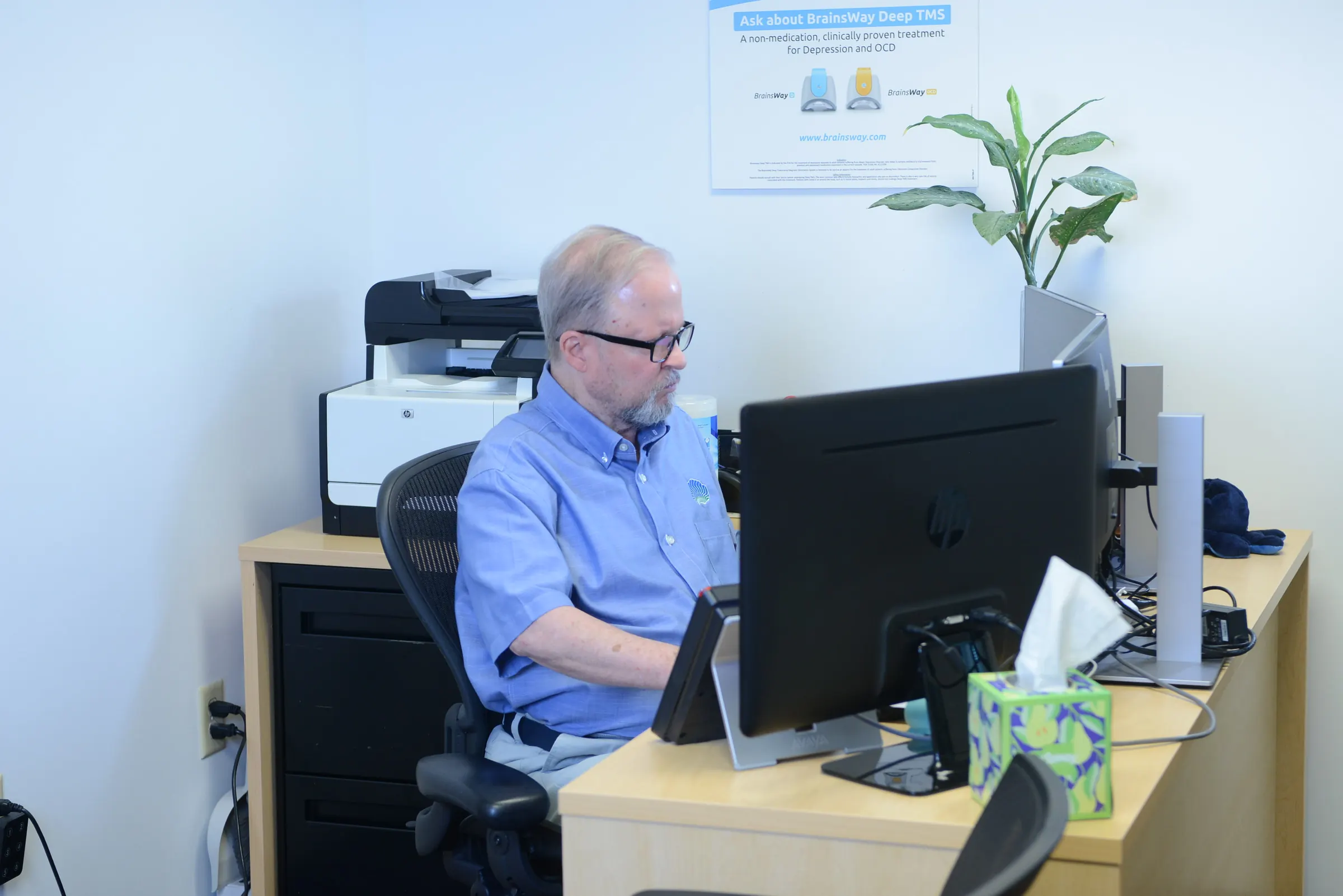 BioMental team member working at a clinic desk.